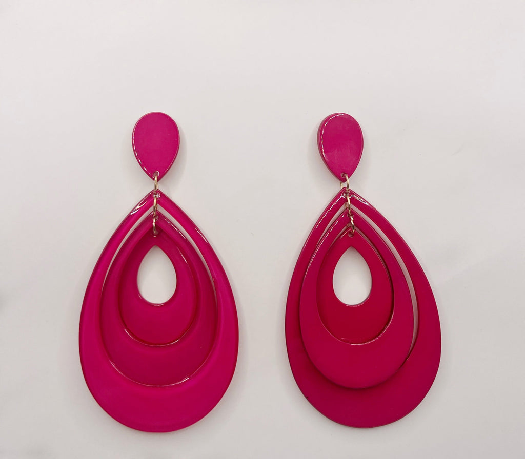 Pair of pink earrings on a light gray background