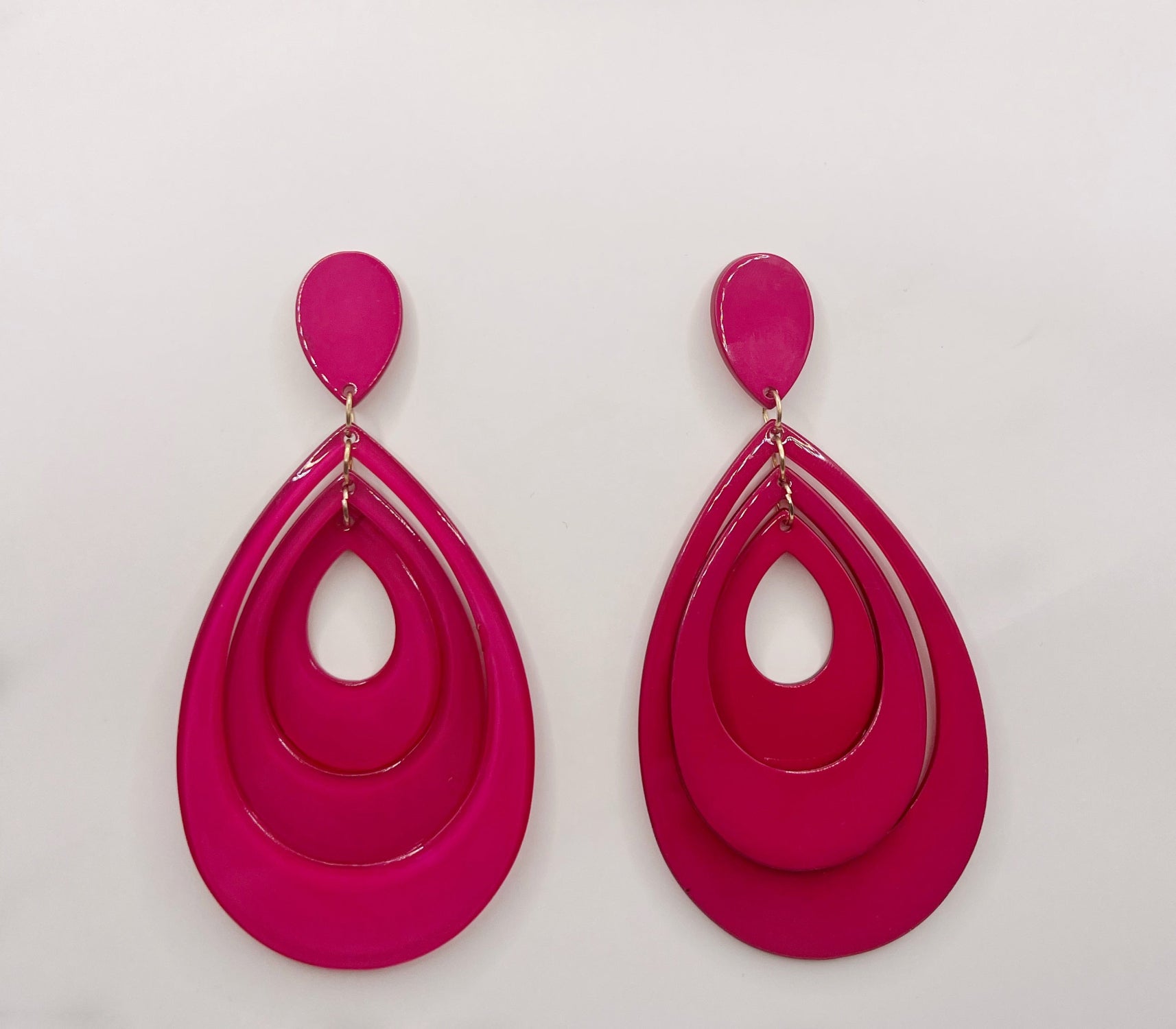 Pair of pink earrings on a light gray background